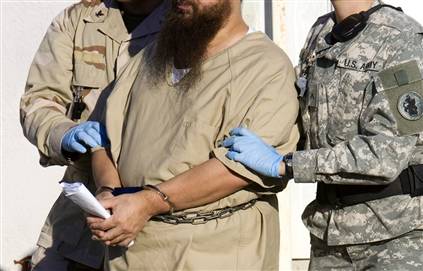 A Guantanamo detainee is escorted from an ARB hearing