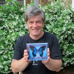 Andy Worthington holding up a copy of 'Love and War' by The Four Fathers, after collecting the first copies from the manufacturers on July 3, 2015.