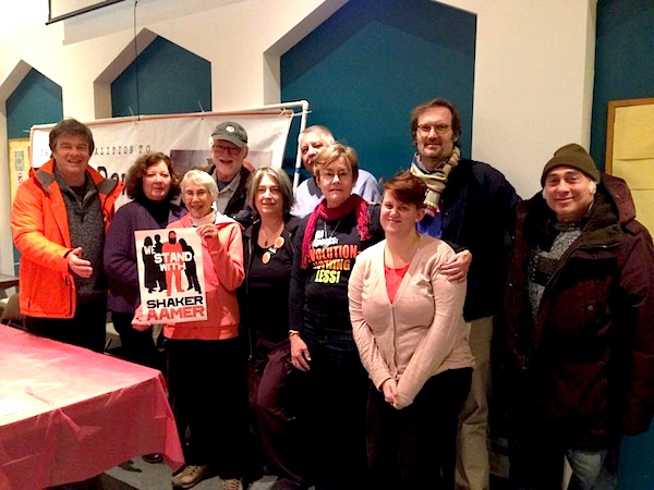 A photo taken at the Chicago Coalition to Shut Down Guantanamo's event in Chicago on January 15, 2015 with Andy Worthington, Candace Gorman, and Debra Sweet (first, second, and fifth from left). The group also includes (L to R) CCSDG regulars Barbara Lyons, Jerry Parker, Mario Vanegas, Jay Becker, Marie Shebeck, Joe Scarry, and Eldon Grossman. Barbara holds a poster from the "We Stand with Shaker Aamer" campaign. (Photo: Lina Thorne.)