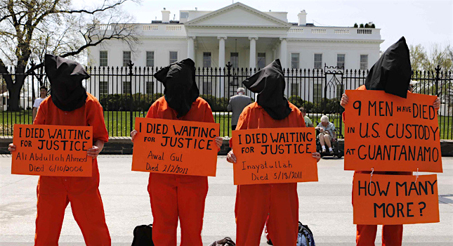 Campaigners with Witness Against Torture remind President Obama of the nine deaths that have occurred at Guantanamo at a protest in April 2013.