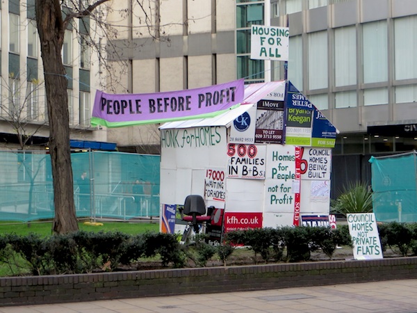 The house made out of estate agents' boards erected outside Lewisham Council's offices in Catford, south east London, by the campaigning group People Before Profit, highlighting housing need in the borough (Photo: Andy Worthington).