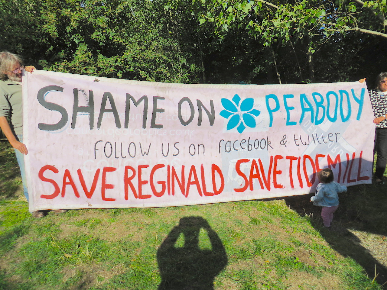 'Shame on Peabody': a banner held by campaigners in the Old Tidemill Wildlife Garden in Deptford, which has been occupied since August 29, 2018 to prevent Lewisham Council and Peabody from destroying it - and 16 structurally sound council flats next door - as part of a housing project (Photo: Andy Worthington).