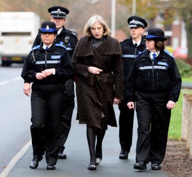 Theresa May flanked by police - a fitting image for the fundamental lack of openness and trust exhibited by our unelected leader.