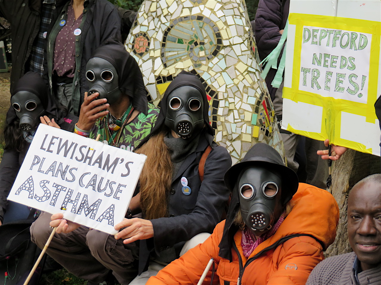 Save Reginald Save Tidemill campaigners photographed wearing gas masks to highlight the environmental costs of the proposed re-development of the old Tidemill school site, including the Old Tidemill Wildlife Garden (Photo: Andy Worthington).