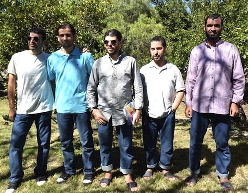 Former Guantanamo prisoners released in Uruguay: from left to right, Ali Hussein al-Shaaban, Ahmed Adnan Ahjam and Abdelhadi Omar Mahmoud Faraj (all Syrians), Tunisian Abdul Bin Muhammad Abbas Ouerghi (aka Ourgy) and Palestinian Mohammed Abdullah Taha Mattan, pose for a picture after lunch at a house in Canelones department, near Montevideo on December 14, 2014 (Photo: Pablo Porciuncula, AFP/Getty Images).